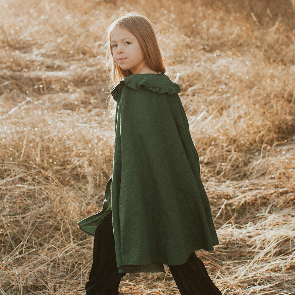 Child wearing pine linen collar cape
