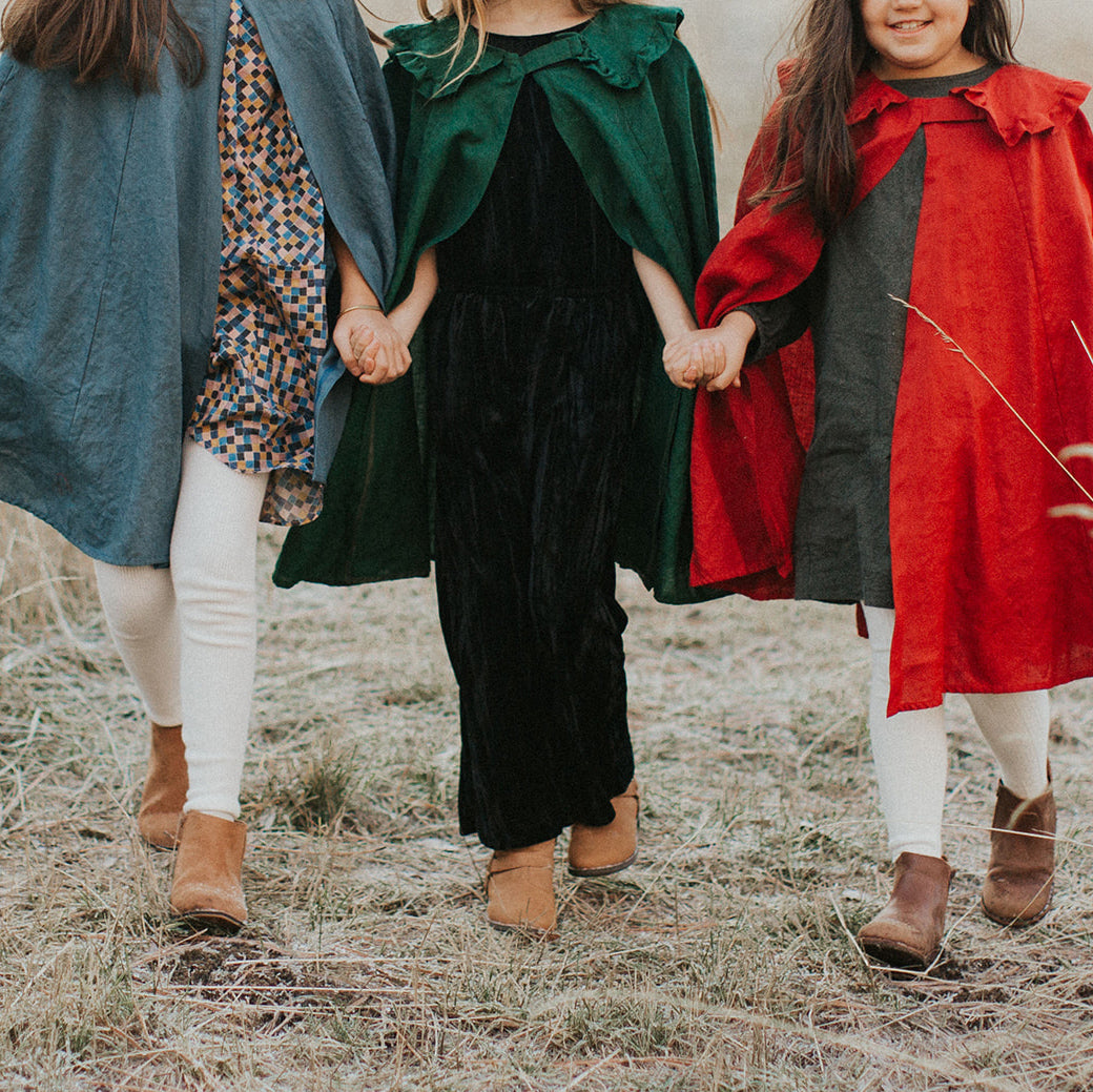 Children wearing linen capes
